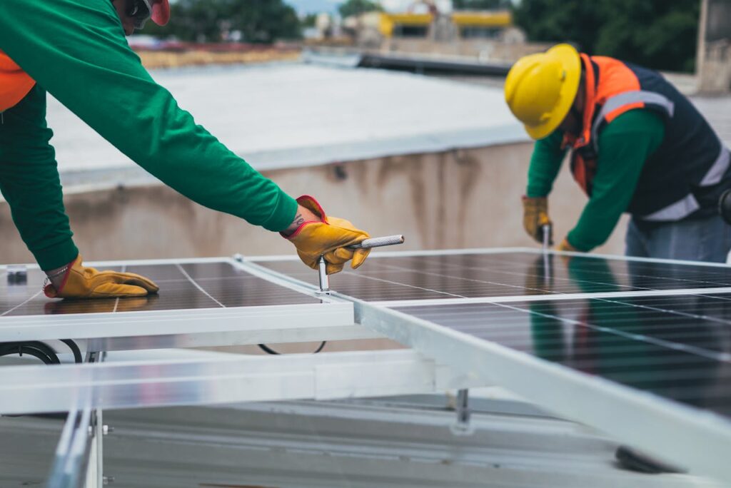 Mastering the First Impression: Your intriguing post title goes here Workers secure solar panels on a rooftop, advancing renewable energy.
